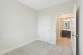 New Richmond house for rent - a bedroom with a white door and a bathroom with a sink and a mirror