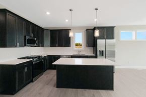 New Richmond house for rent - a kitchen with black cabinets and white counter tops