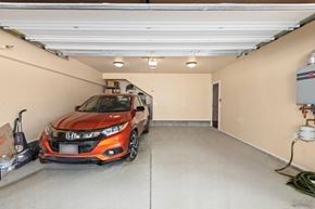 San Diego apartment for rent - A red Honda car is parked in a garage.