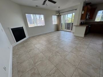 San Diego apartment for rent - A living room with a television and sliding glass doors.
