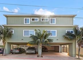 San Diego apartment for rent - A two-story house with a garage and a palm tree in front.