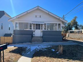 Trinidad house for rent - a white house with a sidewalk in front of it