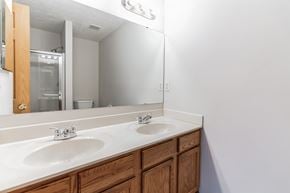 Louisville house for rent - a bathroom with two sinks and a large mirror