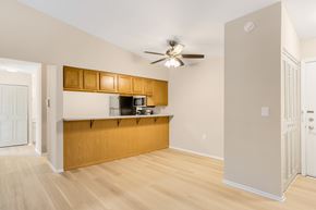 Geneva apartment for rent - A kitchen with wooden cabinets and a ceiling fan.