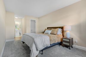 Geneva apartment for rent - A bedroom with a bed, nightstand, and lamp.