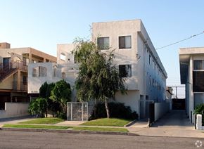 Hawthorne apartment for rent - a white building with a tree in front of it