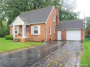 Garden City house for rent - a red brick house with a white garage