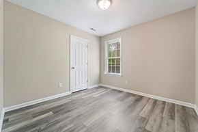 Jacksonville house for rent - A room with a white door and a window with a view of trees.