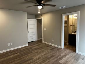 Odessa house for rent - A room with a ceiling fan and wooden flooring.