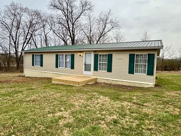 Otisco house for rent - a small house with green shutters and a deck in a grassy field