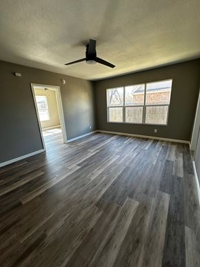 Abilene apartment for rent - an empty living room with wood floors and a ceiling fan