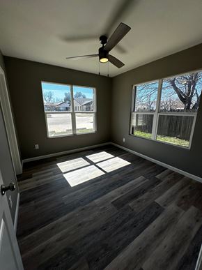 Abilene apartment for rent - an empty living room with wood floors and a ceiling fan