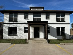 Abilene apartment for rent - a white brick building with a porch and a black door