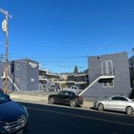 Oakland apartment for rent - a street with cars parked in front of buildings