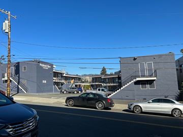 Oakland apartment for rent - a city street with cars parked in front of buildings
