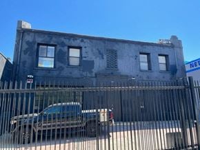 Los Angeles apartment for rent - a truck parked in front of a building behind a fence