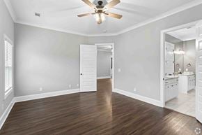 Columbus apartment for rent - A room with a ceiling fan and wooden flooring.