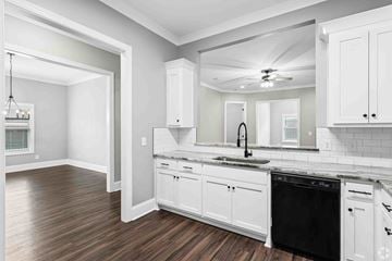Columbus apartment for rent - A kitchen with white cabinets and a black dishwasher.