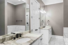 Columbus apartment for rent - A bathroom with a marble countertop and a white door.