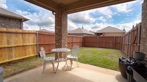 Heartland house for rent - a patio with a table and chairs in a backyard