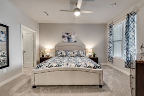 Mckinney house for rent - a bedroom with a bed and a ceiling fan