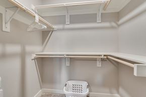 Mckinney house for rent - a walk in closet with shelves and a laundry basket