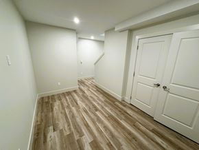 Kentville apartment for rent - a bedroom with white walls and white doors and wood flooring