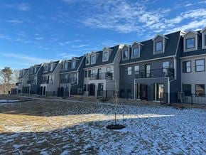 Kentville apartment for rent - a snow covered yard in front of a row of houses