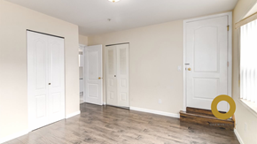 Vancouver house for rent - a living room with white doors and a hard wood floor