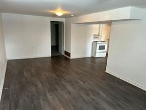Prince Albert house for rent - an empty living room with wood flooring and a kitchen