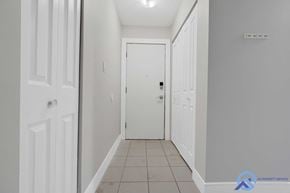 Edmonton apartment for rent - A hallway with white doors and tiled flooring.