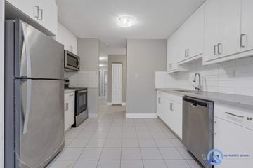 Edmonton apartment for rent - A kitchen with white cabinets and a stainless steel refrigerator.