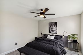 Baltimore apartment for rent - a bedroom with a bed and a ceiling fan