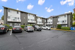 District Heights apartment for rent - a parking lot with cars in front of an apartment building