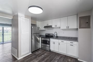 Essex apartment for rent - A modern kitchen with white cabinets and stainless steel appliances.