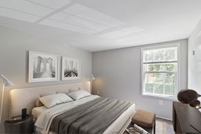 Essex apartment for rent - A bedroom with a bed, nightstand, and two pictures on the wall.