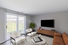 Essex apartment for rent - A living room with a television, two chairs, a couch, and a chess board on the coffee table.