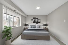 Capitol Heights apartment for rent - a bedroom with a bed and a large window