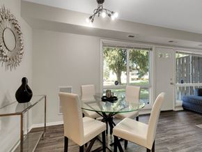 Suitland apartment for rent - a dining room with a glass table and white chairs