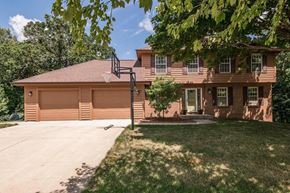 Rochester house for rent - A house with a brown roof and a basketball hoop on the garage.