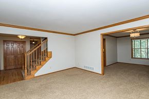 Rochester house for rent - A spacious room with a staircase and a window.