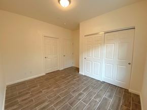 Merced house for rent - a bedroom with two closets and a tiled floor