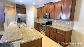 Clermont house for rent - a kitchen with granite counter tops and wooden cabinets