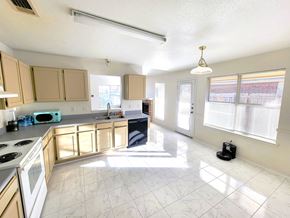 Killeen house for rent - a kitchen with wooden cabinets and a stove and a sink