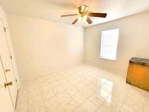 Killeen house for rent - an empty living room with a ceiling fan and a tiled floor