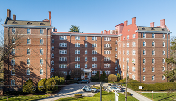 Bryn Mawr apartment for rent - A large red brick building with a green lawn in front.