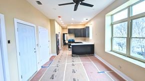 Chicago apartment for rent - a kitchen is being remodeled with wood floors and a ceiling fan