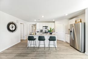 Salisbury apartment for rent - a kitchen with stainless steel appliances and a counter with three stools