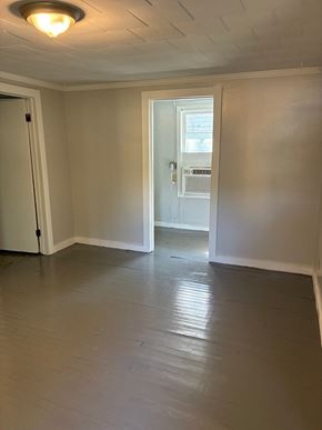 Mobile house for rent - A room with a door and a window.