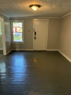 Mobile house for rent - A room with a white door and a window.
